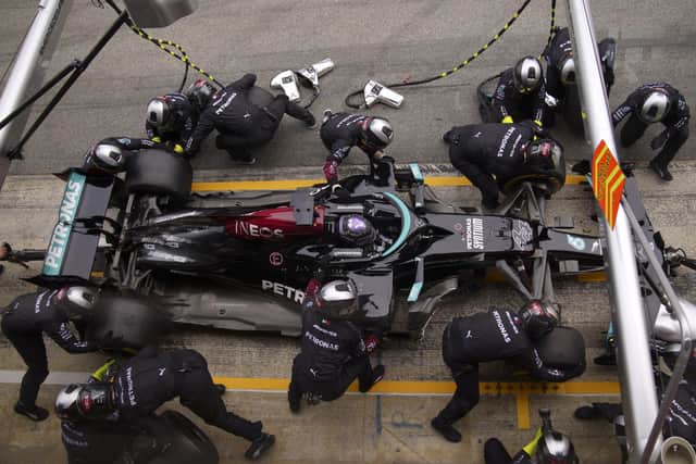 Mercedes driver Lewis Hamilton of Britain stops in the pit lane to change tires during the Spanish Formula One Grand Prix. (AP Photo/Emilio Morenatti)