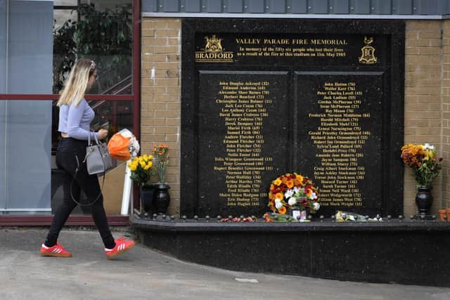 Pictured, a member of the public takes flowers to lay at the memorial on the 35th Anniversary of the Bradford City Fire Disaster, Valley Parade, Bradford in May 2020..Photo credit: JPIMedia/ Simon Hulme