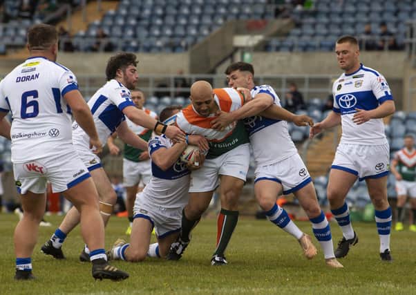 BACK AT IT: Hunslet's Alex Rowe takes some stopping by the Town's defence. Picture: Tony Johnson.