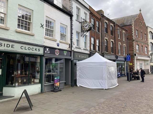 A police tent outside The Clean Plate cafe in Southgate Street, Gloucester, on Tuesday (May 11).