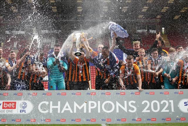 TOP DOGS: Hull City players celebrate with the League One trophy after their final game of the season against Charlton Athletic at The Valley, London. Picture: Steven Paston/PA
