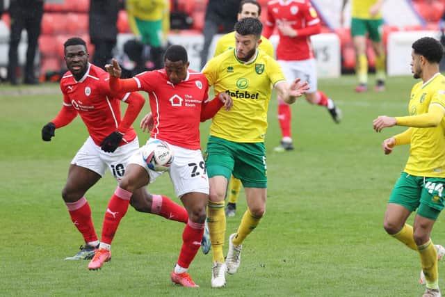 HIGH AIMS: Victor Adeboyejo of Barnsley battles with Norwich City's Grant Hanley in their final league game of the season at Oakwell on Saturday. Picture: John Clifton/Sportimage