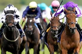 Snowfall ridden by Ryan Moore (right) on their way to winning the Tattersalls Musidora Stakes during day one of the Dante Festival at York Racecourse.