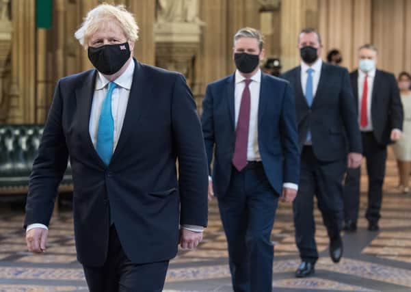 Prime Minister Boris Johnson (left) and Labour leader Sir Keir Starmer (2nd left) walk through the Central Lobby on the way to the House of Lords to listen to the Queen's Speech. Picture: Stefan Rousseau/PA Wire