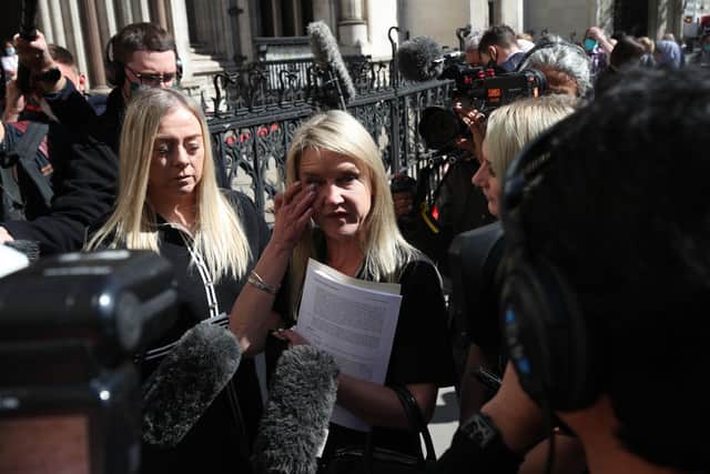 Former post office worker Janet Skinner (centre), with her niece Hayley Adams (right) and her daughter Toni Sisson, celebrating outside the Royal Courts of Justice, London, after having her conviction overturned by the Court of Appeal. Thirty-nine former subpostmasters who were convicted of theft, fraud and false accounting because of the Post Office's defective Horizon accounting system have had their names cleared by the Court of Appeal.
