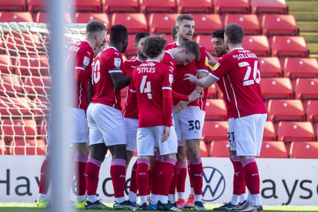Tight-knit bunch: Barnsley players celebrate Cauley Woodrow's early goal against Millwall. Picture: Tony Johnson