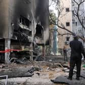 Israeli men check the damages after a rocket attack from the Hamas-controlled Gaza Strip, in the central Israeli city of Petah Tikva