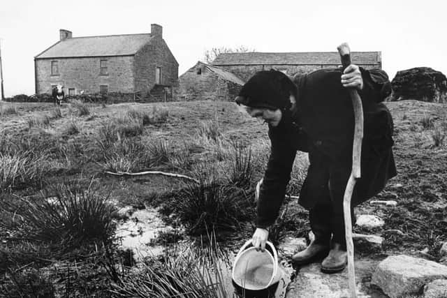 Hannah Hauxwell pictured drawing her water for domestic use at her farm in Baldersdale. Photographer Mike Cowling took this picture of Hannah in the early 1980's before she left the remote farm for the Co. Durham village of Cotherstone