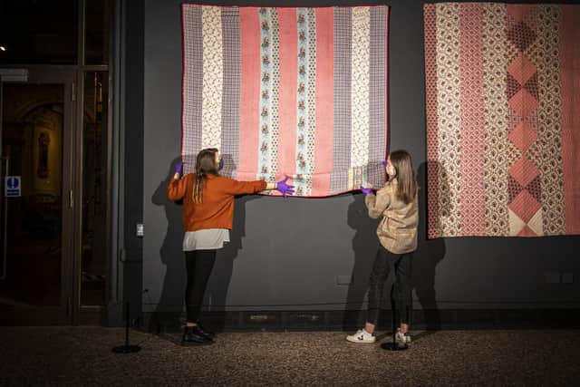 Exhibition assistants Catherine Dickinson and Sarah Webster with a quilt made by Hannah Hauxwell’s grandmother Elizabeth Bayles is to feature in a new exhibition having been secured at auction by the Bowes Museum in Barnard Castle. Image: Tony Johnson