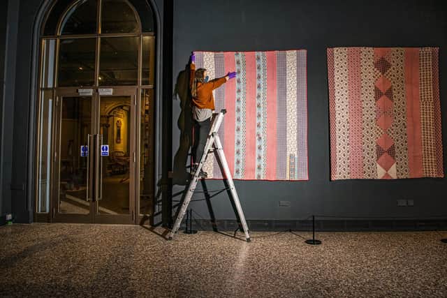 An exhibition assistant with a quilt made by Hannah Hauxwell’s grandmother Elizabeth Bayles, which is to feature in a new exhibition having been secured at auction by the Bowes Museum in Barnard Castle. Image: Tony Johnson
