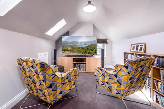 Good use has been made of the roof space while a neutral colour scheme is livened by the bright, geometric armchairs