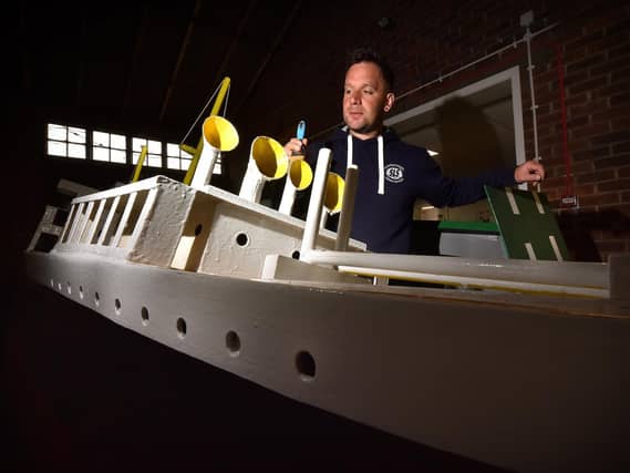 The Scarborough Naval Warfare Battle ships are currently in storage at Scarborough's Council depot where maintainance is taking place before the season starts..Naval Warfare Coordinater Damien Rhodes painting one of the boats . Image by Richard Ponter
