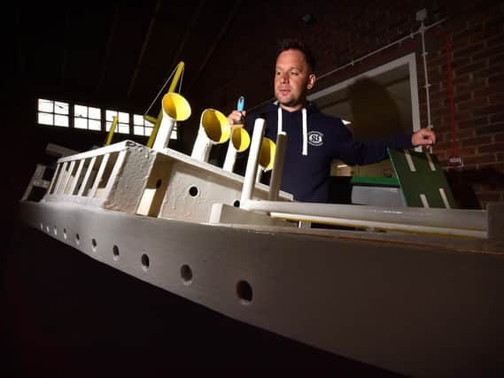 The Scarborough Naval Warfare Battle ships are currently in storage at Scarborough's Council depot where maintainance is taking place before the season starts..Naval Warfare Coordinater Damien Rhodes painting one of the boats . Image by Richard Ponter
