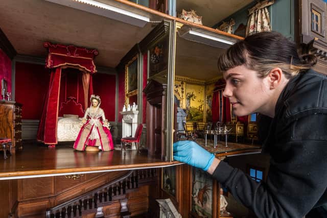 Sophie Bryan, Collections Assistant for the National Trust at Nostell Priory, taking great care to inspect the famous Dolls House before cleaning.