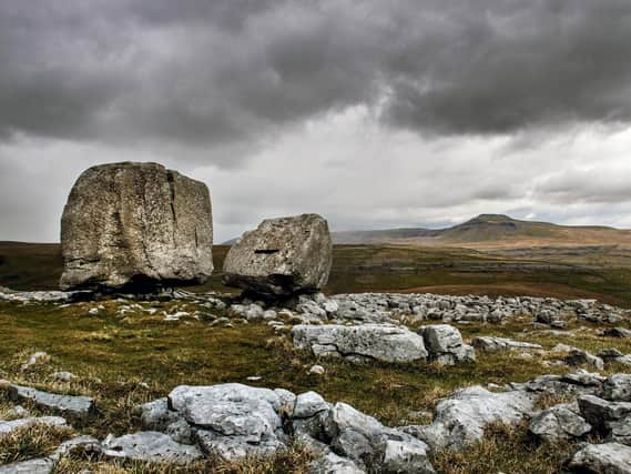 The Cheese Press stone above the limestone escarpment of Kingsdale north of Ingleton looking towards Ingleborough. Picture: Bruce Rollinson