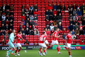 GOOD TO BE BACK: Barnsley fans watch from the stands at Oakwell. Picture: Nick Potts/PA