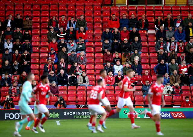 GOOD TO BE BACK: Barnsley fans watch from the stands at Oakwell. Picture: Nick Potts/PA