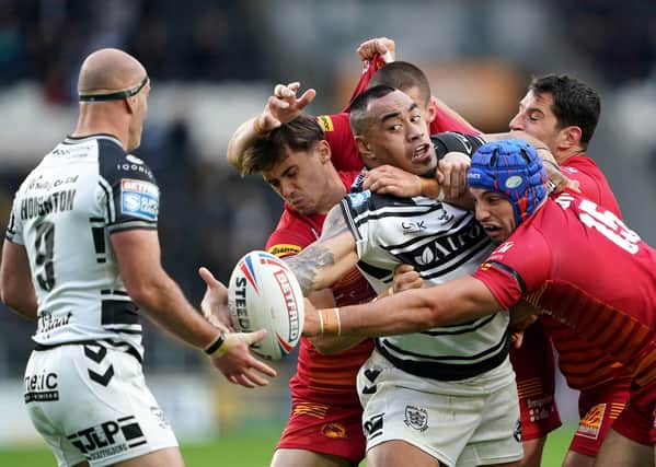 Hull FC's Mahe Fonua (middle) is tackled by Catalans Dragons' Benjamin Jullien. Pictures: Zac Goodwin/PA Wire.