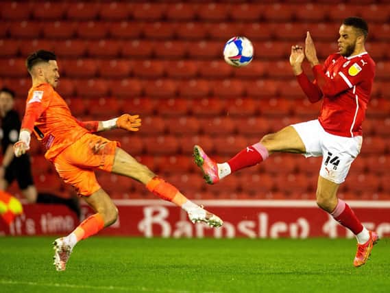 CHALLENGE: Barnsley's Carlton Morris competes for the ball with Freddie Woodman