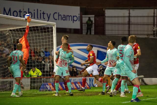 CLOSE CALL: Swansea goalkeeper Freddie Woodman tips Carlton Morris's shot over the crossbar late on at Oakwell on Monday night. Picture: Bruce Rollinson