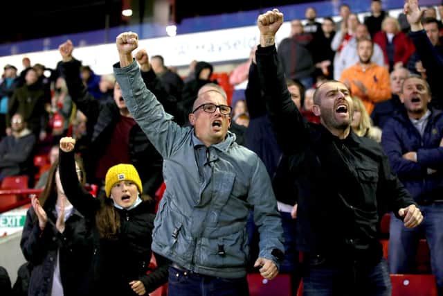 PASSION: Barnsley fans cheer from the stands during the Championship Playoff Semi Final, First Leg match against Swansea City at Oakwell on Monday night. Picture: Nick Potts/PA
