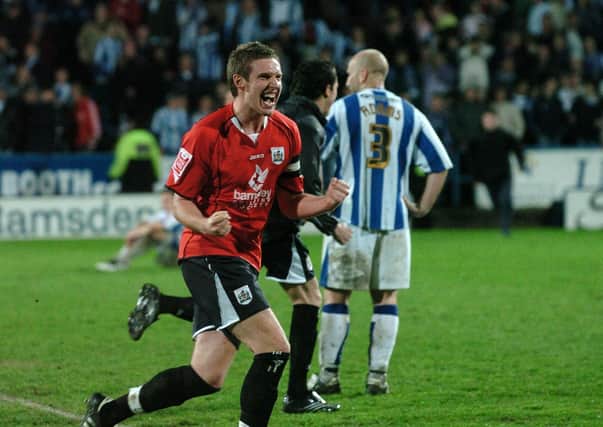 Job done: Barnsley's Paul Reid celebrates at Huddersfield Town as his team gain a place in the League One play-off final. Pictures: Bruce Rollinson