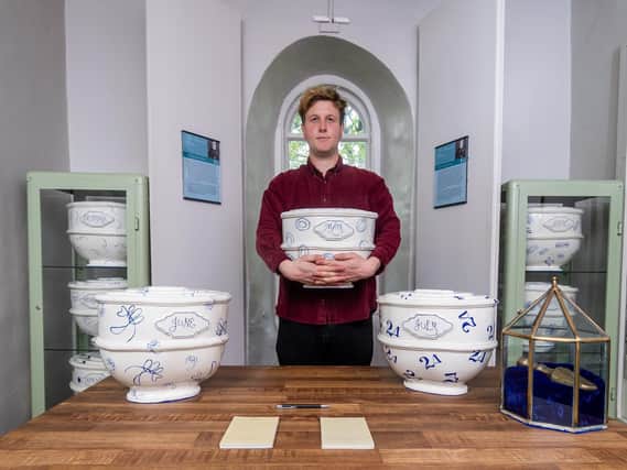 Harry Jelley, the audience development officer for the Brontë Parsonage Museum in Haworth, is pictured with ceramic works by artist Layla Khoo. The museum re-opened to the public on Wednesday, May 19, after the latest easing of lockdown restrictions. (Picture: James Hardisty)