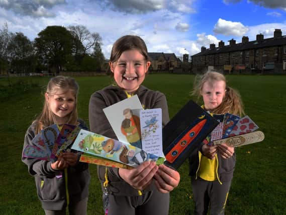 Pictured from the left are Olivia Frobisher, Mabel Tricklebank and Evie Harding with some of the bookmarks. Picture by Simon Hulme