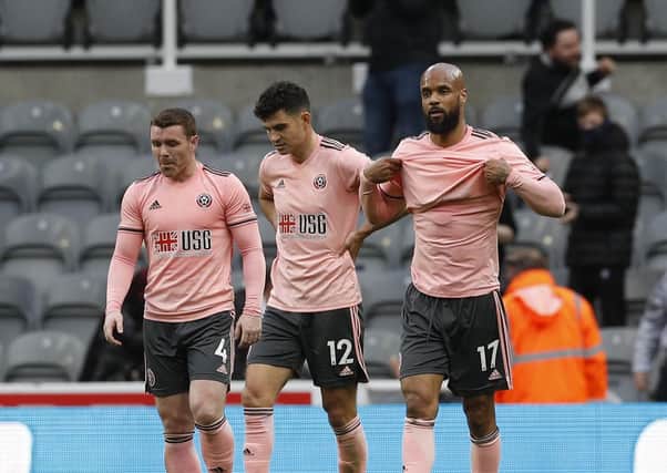 One too many: The Blades trio of John Fleck, left, John Egan, centre, and David McGoldrick, right, look dejected after Newcastle opened the scoring. (Picture: Darren Staples/SportImage)