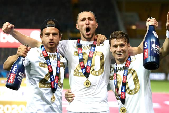 Leeds United's Gaetano Berardi (left), Luke Ayling and Ezgjan Alioski (right) celebrate winning the Championship.