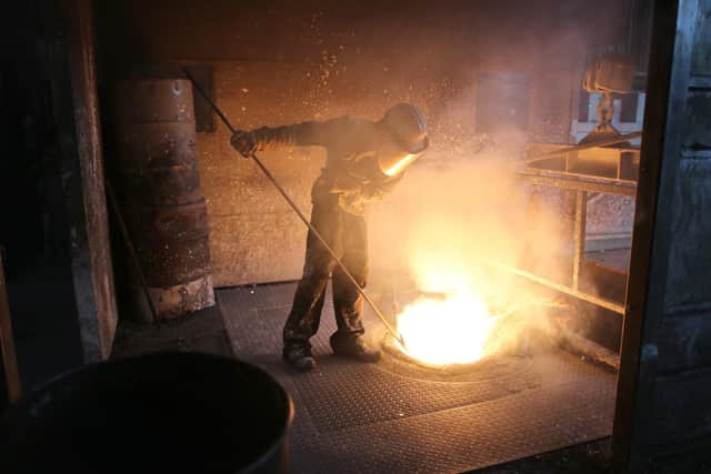 A worker tends to the furnace producing ferrotitanium during a visit to Tivac Alloys in Rotherham. Pic: Getty Images