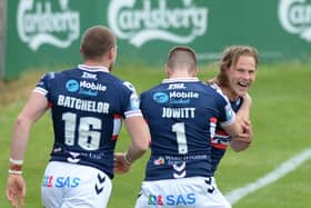 Happy return: Wakefield Trinity's Jacob Miller celebrates after scoring a try on his return from injury, with Max Jowitt and James Batchelor.  Picture: Dean Williams