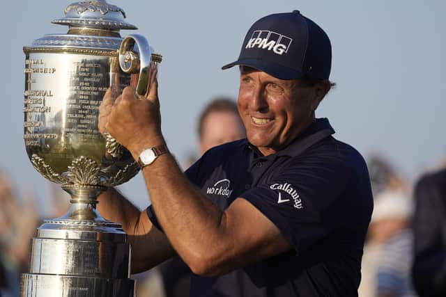 Phil Mickelson holds the Wanamaker Trophy after winning the PGA Championship golf tournament on the Ocean Course at Kiawah Island.