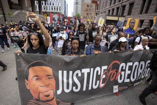 People march for the one year anniversary of George Floyd's death on Sunday, May 23, 2021, in Minneapolis, Minn. (AP Photo/Christian Monterrosa)