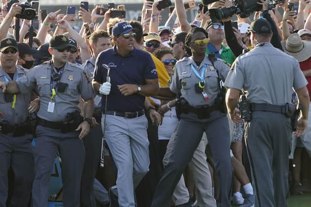 Phil Mickelson wades through fans on the 18th fairway during the final round at the PGA Championship golf tournament on the Ocean Course, Sunday, May 23, 2021, in Kiawah Island. (AP Photo/Matt York)