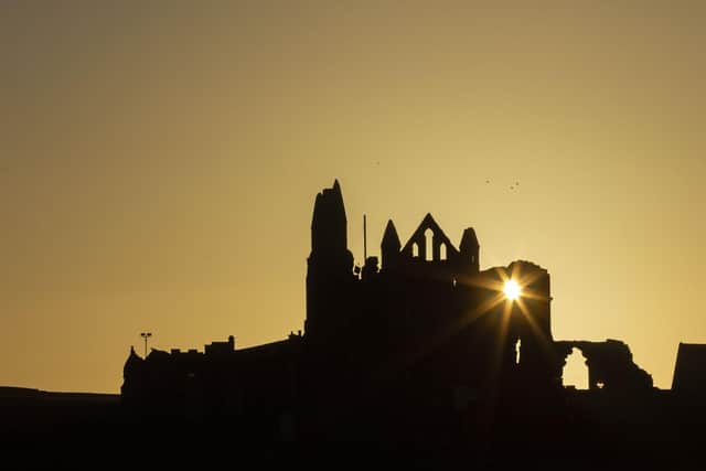 The sun rises behind Whitby Abbey as the town welcomes back visitors.