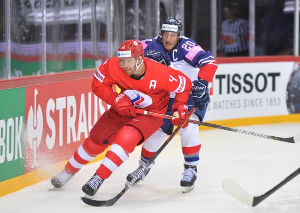 CAPTAIN FANTASTIC: Jonathan Phillips battles for the puck against Russia in Riga. Picture: Dean Woolley.