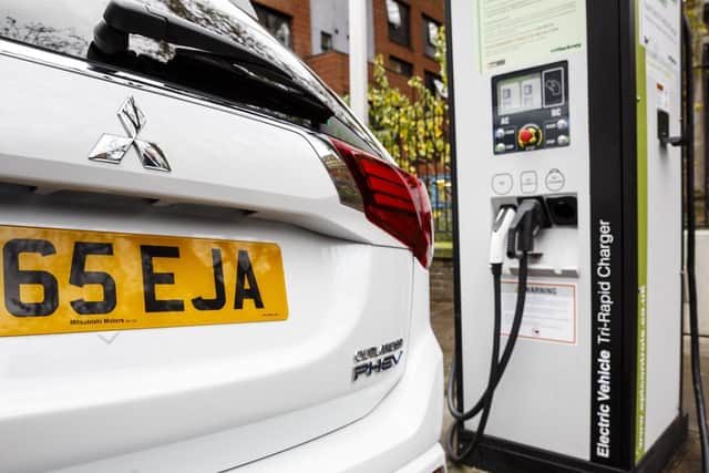 Go Ultra Low Mitsubishi Outlander PHEV on charge on a London street. Ultra-low emission vehicles such as this can cost as little as 2p per mile to run and some electric cars and vans have a range of up to 700 miles. 2016 pic by Getty Images
