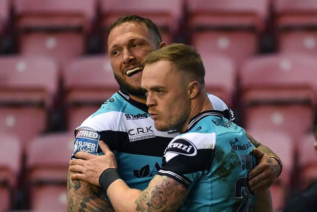 Hull's Adam Swift celebrates scoring his side's first try against Wigan with Josh Griffin.  Picture: Jonathan Gawthorpe