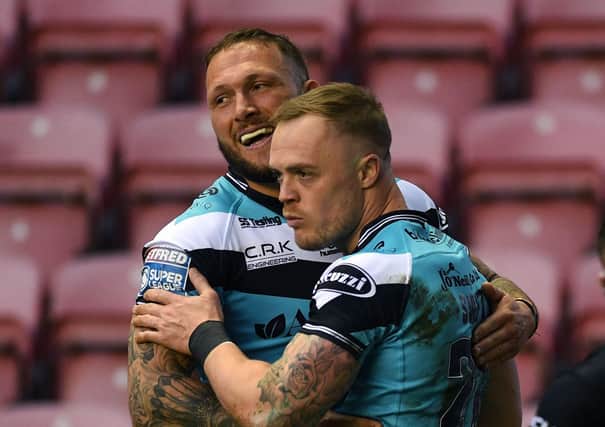 Hull's Adam Swift celebrates scoring his side's first try against Wigan with Josh Griffin.  Picture: Jonathan Gawthorpe
