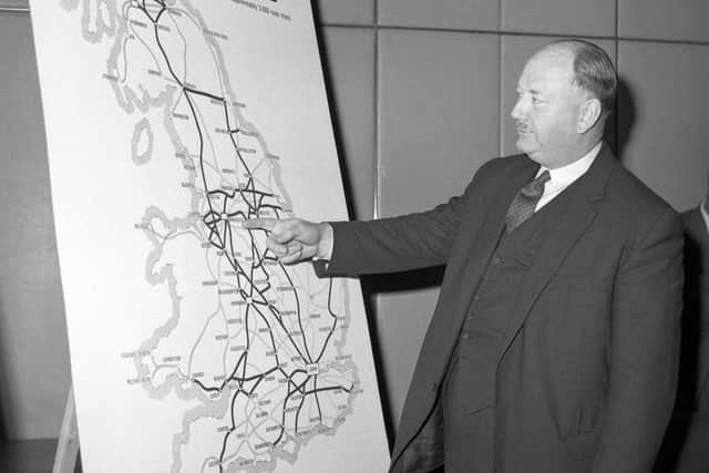 Dr Richard Beeching looking at a map of the railways in the 1960s.