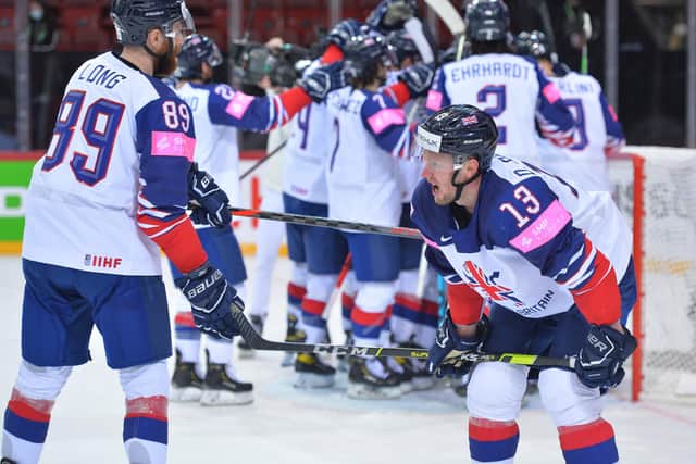 A JOB WELL DONE: GB defenceman Davey Phillips takes a moment as the celebrations begin behind him following the 4-3 win over Belarus in Riga. Picture: Dean Woolley.