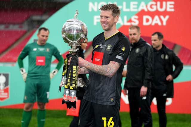 Signing off: Harrogate Town's Jon Stead celebrates with the FA Trophy at Wembley Stadium.