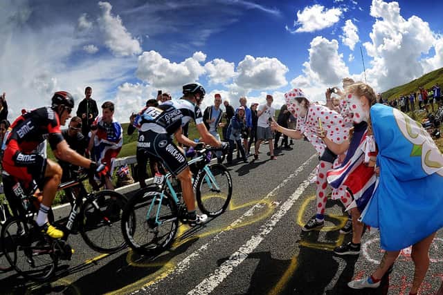 Fans Cheer on cyclists as they tackle the Holme Moss climb on the Tour de France Stage 2 in 2014. Picture by Simon Hulme