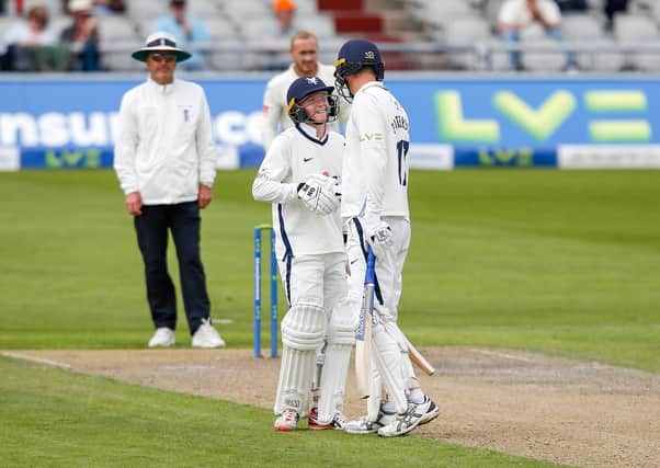 Teenager Harry Duke and captain Steve Patterson share a smile on a tough opening day for Yorkshire in the Roses match against Lancashire at Old Trafford. Picture: John Heald