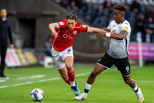 HARD-FOUGHT: Callum Brittain and Jamal Lowe chase the ball at the Liberty Stadium in the playoff semi-final second leg.  Picture: Bruce Rollinson