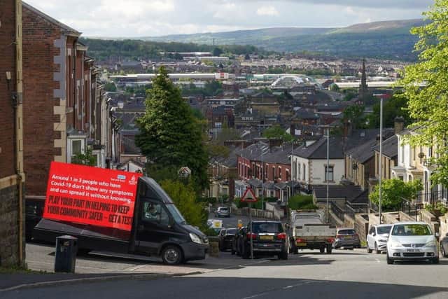 An electronic Covid-19 warning billboard drives around the streets in Blackburn as the Indian variant of coronavirus causes concern for health authorities on May 18, 2021. (Photo by Christopher Furlong/Getty Images)