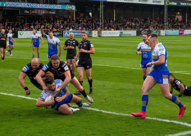 Tom Briscoe scores in Leeds Rhinos' 60-6 win over Castleford Tigers in Super League on Friday night.  Picture: Bruce Rollinson