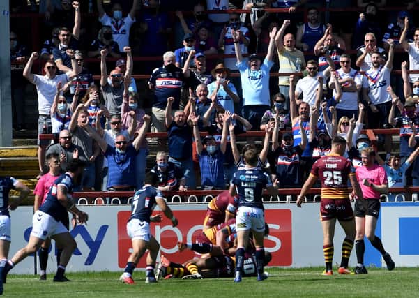 Wakefield's crowd cheers on Trinity as they score there fourth try. Pictures: Simon Hulme