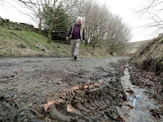Holme Valley South councillor Donald Firth inspects damage to a green lane route used by bikers and 4×4 drivers. (Image: Andy Catchpool)